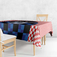 Blue and black jersey graphic tablecloth with red-and-white checkered edge on bench