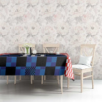 Blue and black jersey graphic tablecloth with red-and-white trim on dining table