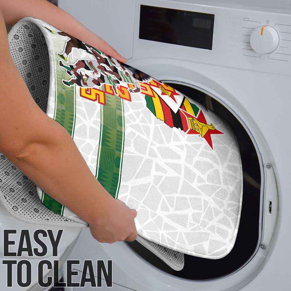 Washable bath rug with green stripe and team graphic shown in a washing machine