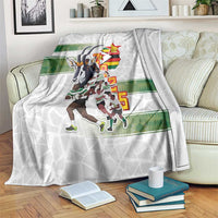 White rugby blanket with Zimbabwe Warriors graphic and green stripe