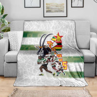 White rugby blanket with Zimbabwe Warriors players graphic and green band