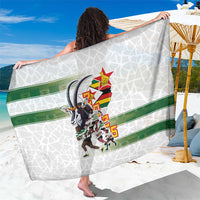 White rugby sarong with green stripe and emblem graphic, draped towel-style