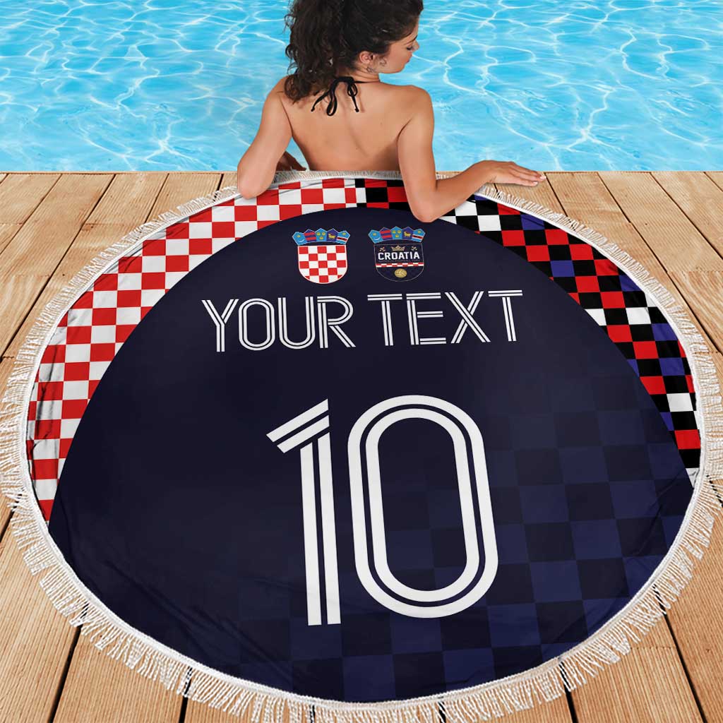 Round beach blanket with dark navy checkered graphic, Croatia crests and oversized '10', fringe