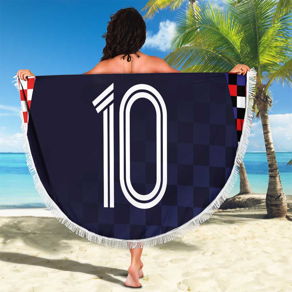 Round beach blanket held up, dark navy checkered border, Croatia crest and '10' print, fringe
