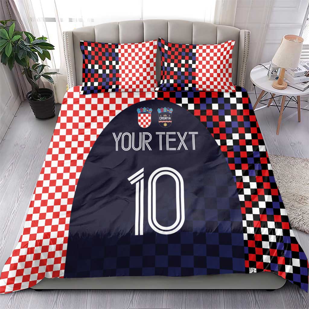 Bedding set on a bed: red-and-white checker pillows with navy duvet showing custom text and number 10