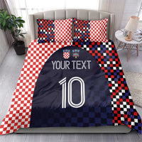 Bedding set on a bed: red-and-white checker pillows with navy duvet showing custom text and number 10