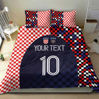 Bedding set featuring red-and-white checker pillows and navy duvet with custom text and number 10