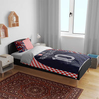 Bedding set on a bed: navy duvet with custom text and number 10 plus checker red-and-white pillows