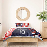Bedding set with navy duvet featuring custom text and number 10, paired with red-and-white checker pillows
