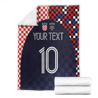 Folded dark navy football blanket with red-white checkered border, 'YOUR TEXT' and 10