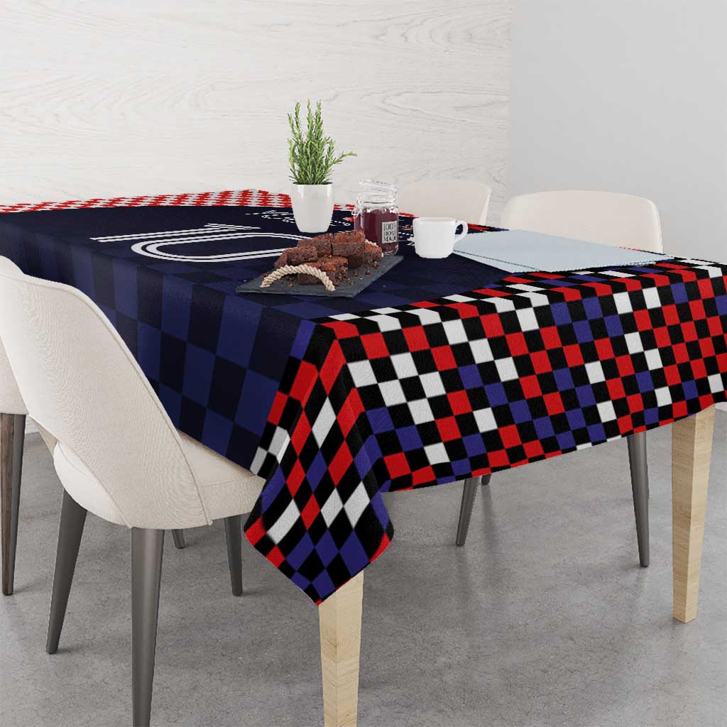 Dark navy checkered tablecloth with bold red, black, and white square pattern