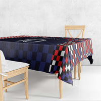 Folded corner view of dark navy checkered tablecloth with red, black, and white squares