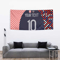 Wall tapestry above gray sofa: red checkers, dark navy pattern with 'YOUR TEXT' and 10