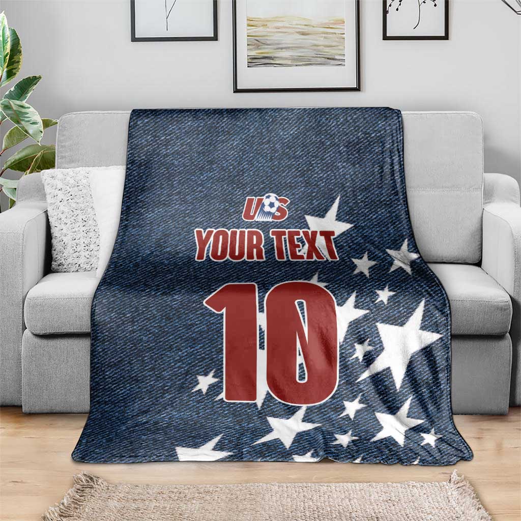 Navy retro denim-style soccer blanket draped on a couch with US logo, stars, and number 10
