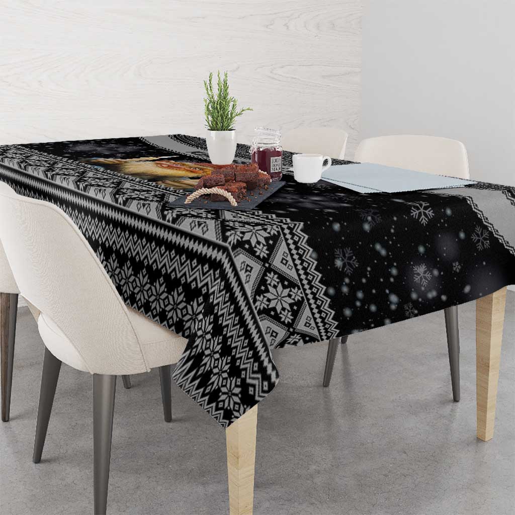Black Nordic tablecloth with snowflake and diamond patterns, coffee cups on table