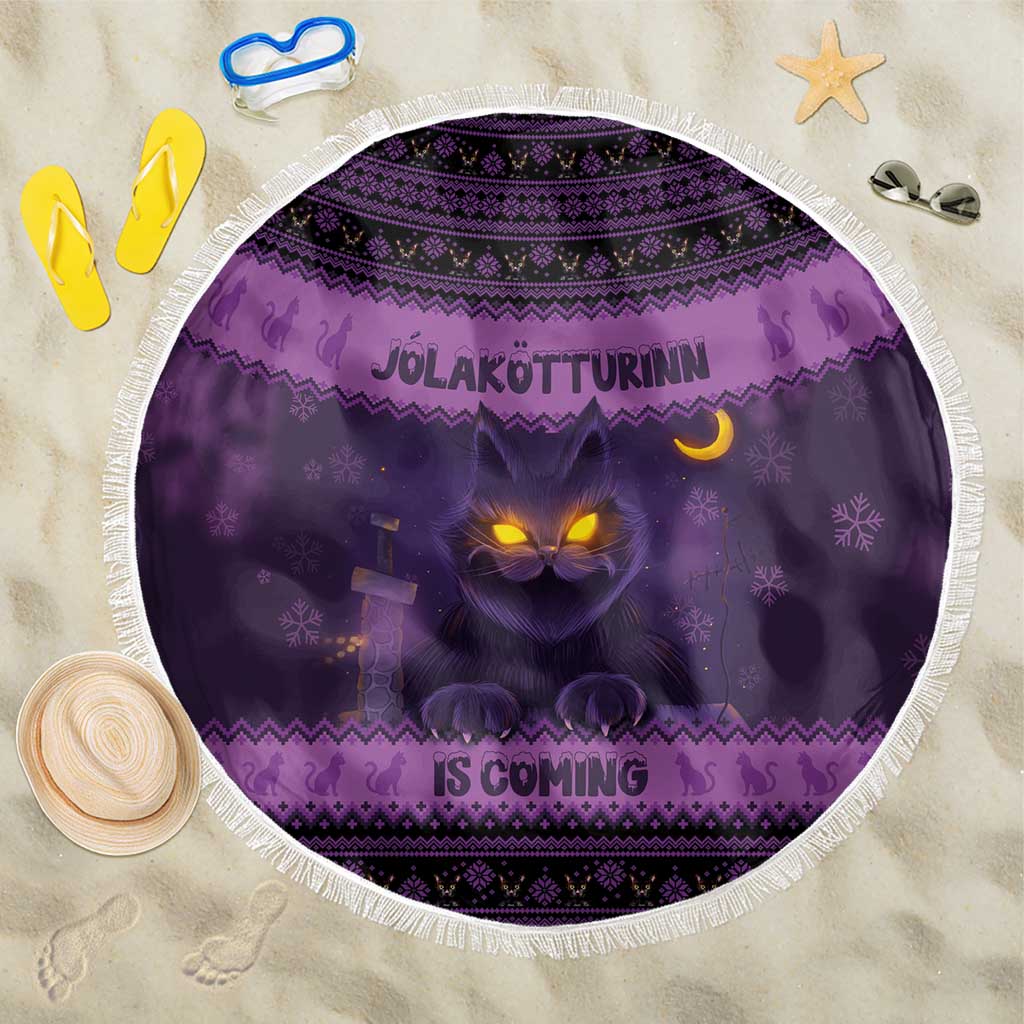 Dark purple round beach blanket with glowing cat face and Nordic pattern, fringed edge