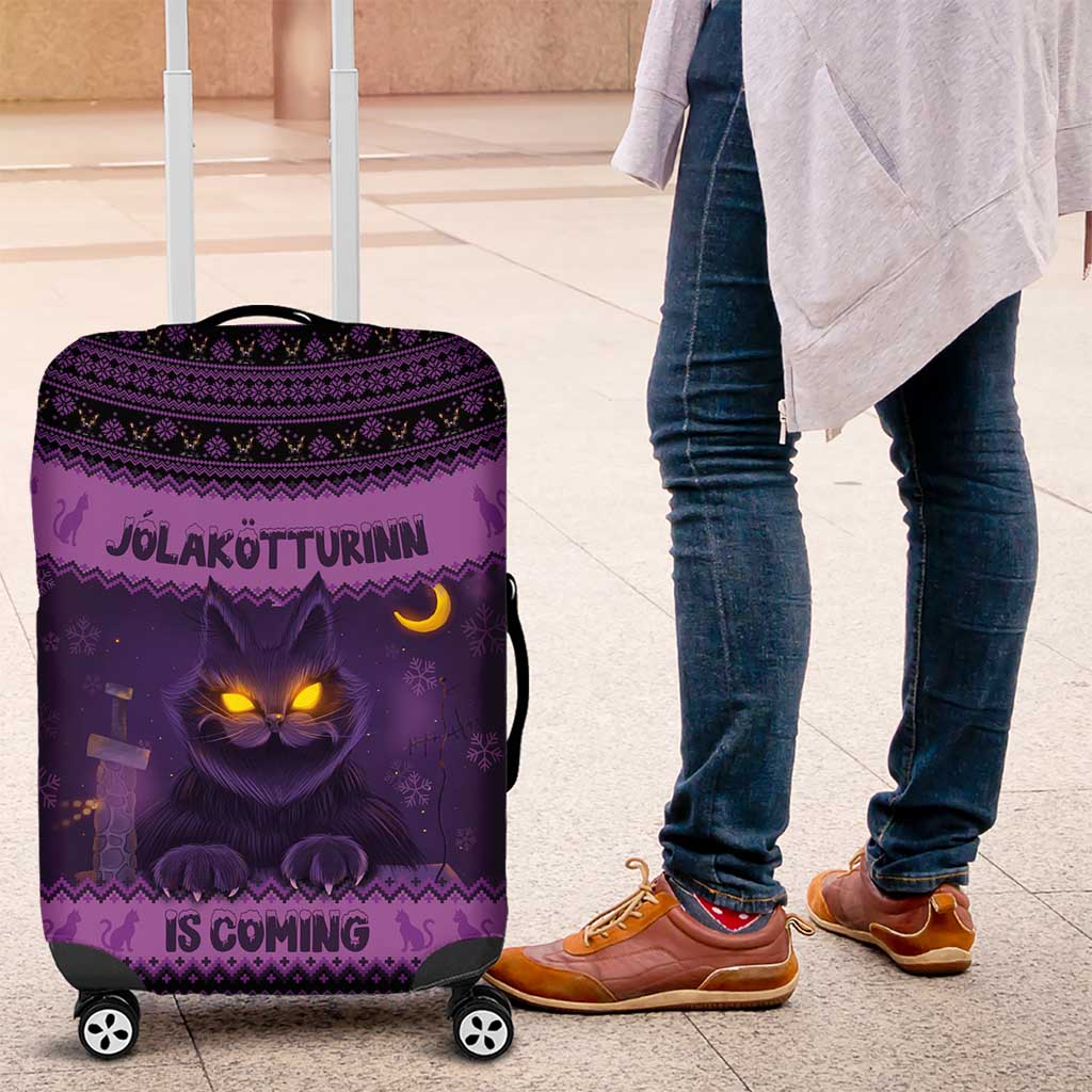 Dark purple Christmas luggage cover with glowing cat face and Nordic-style pattern on wheels