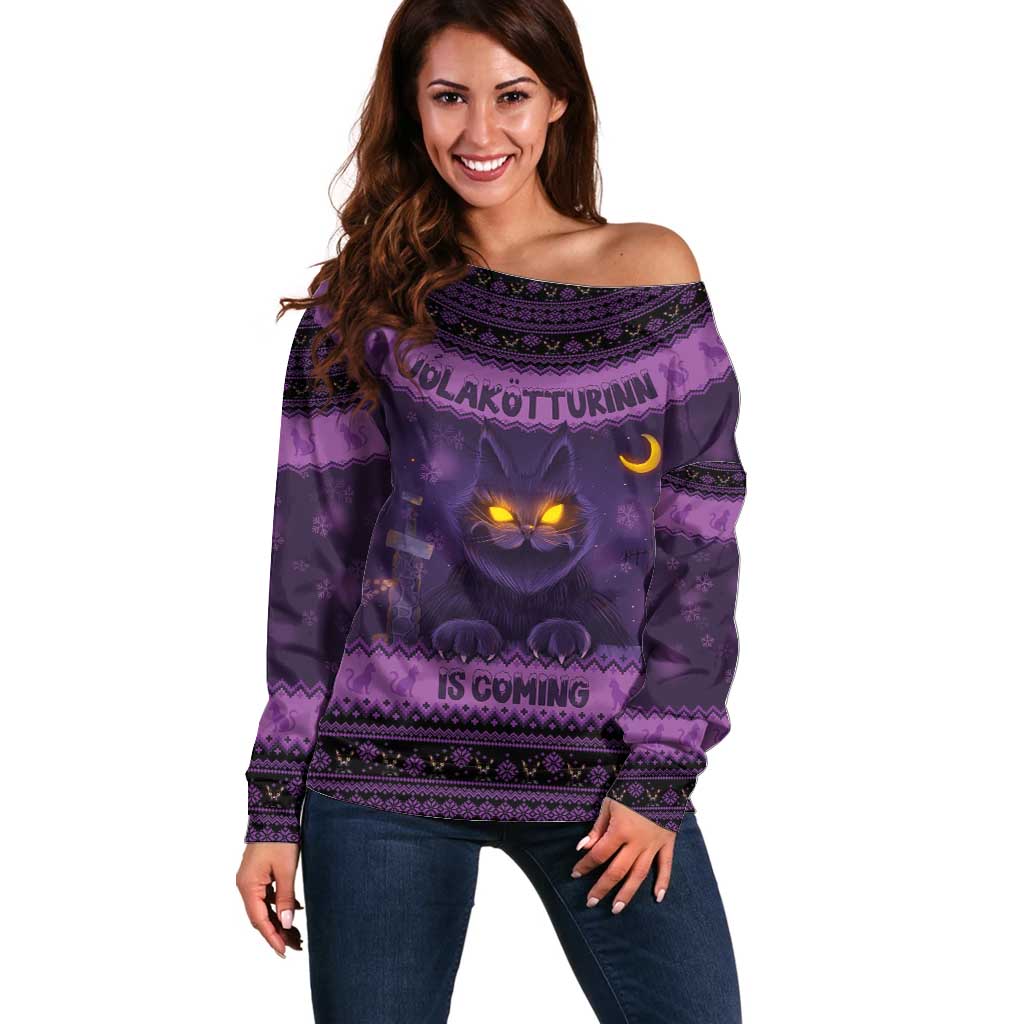 Women’s dark purple off-shoulder sweater with “Is Coming” text and cat-face graphic