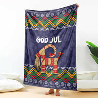 Dark blue Christmas blanket with GOD JUL, standing goat illustration, and colorful zigzag trim