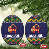 Set of two dark blue oval ceramic ornaments with goat and “GOD JUL” folk pattern, hanging strings