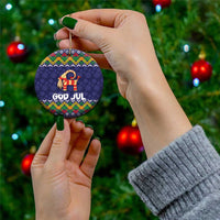 Dark blue round ceramic ornament with folk goat design and “GOD JUL” text on hanging string