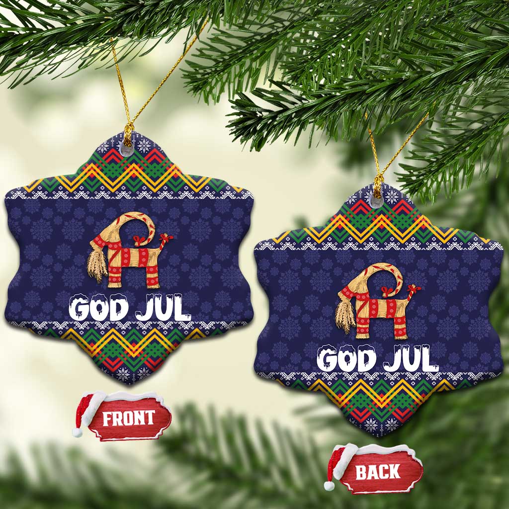 Set of two dark blue snowflake-shaped ceramic ornaments with goat and “GOD JUL” text