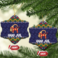 Set of two dark blue snowflake-shaped ceramic ornaments with goat and “GOD JUL” text