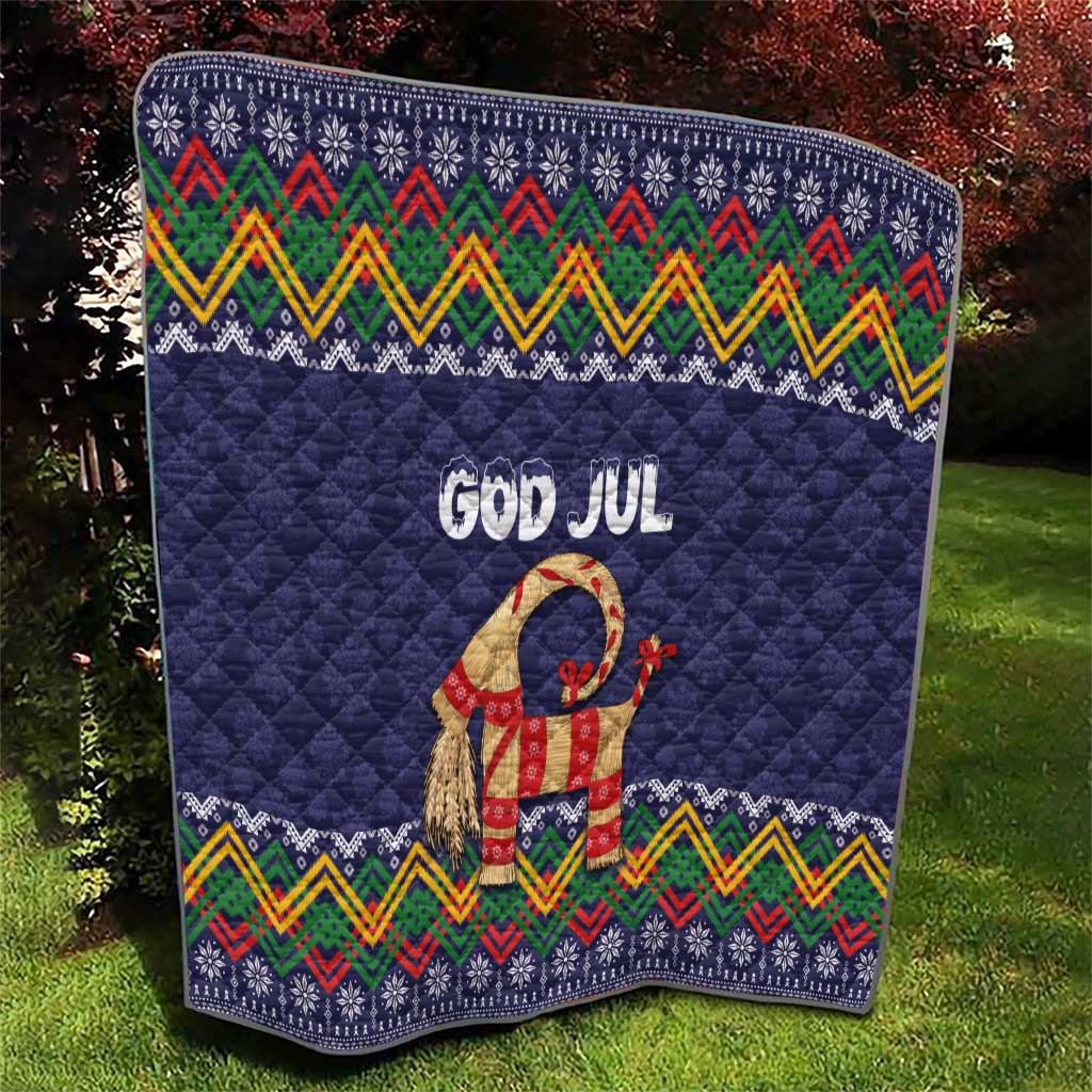Dark blue quilt blanket with “God Jul” lettering, goat figure, and folk pattern band trim