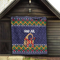 Dark blue quilt with “God Jul” goat figure and multicolor zigzag folk trim