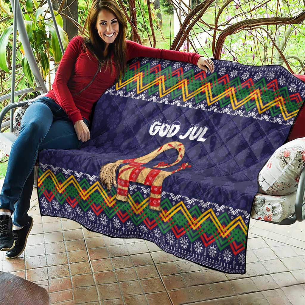 Dark blue quilt blanket with “God Jul” and goat motif, colorful chevrons and border patterns