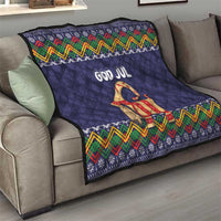 Dark blue quilt throw with “God Jul” goat motif and multicolor zigzag border