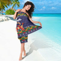 Dark blue Christmas sarong with colorful chevron edge and goat “GOD JUL” print