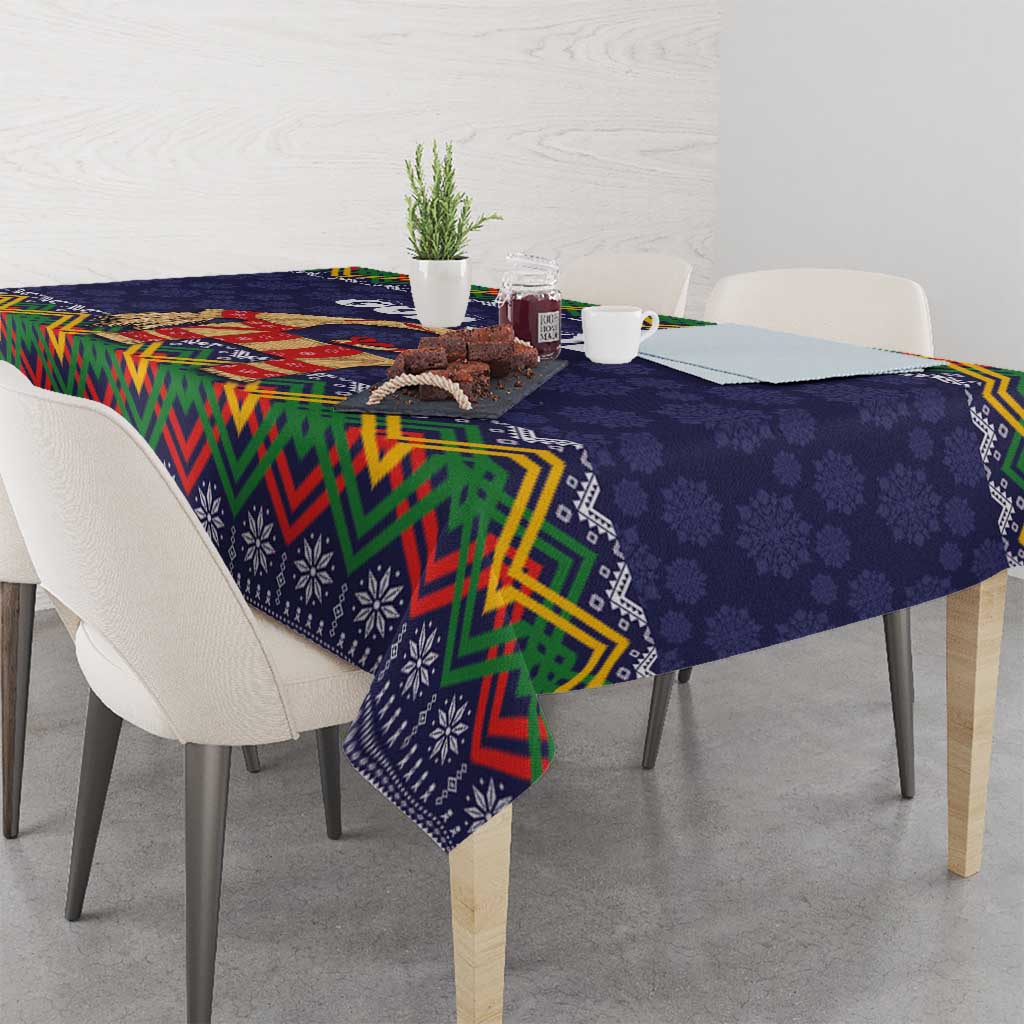 Dark blue tablecloth with colorful zigzag edge and small snowflake-like folk motifs