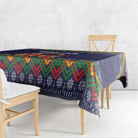 Dark blue tablecloth draped over table with colorful chevron border and folk motifs