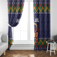 Dark blue Christmas curtain panels with “God Jul” lettering and goat figure, full window view.
