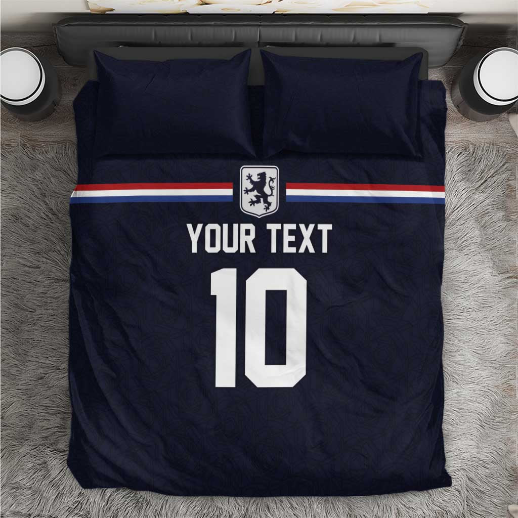 Dark navy bedding set with two pillows, soccer crest and 'YOUR TEXT 10' graphic
