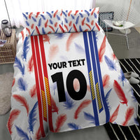 Bedding set with feather-and-striped duvet cover showing custom “YOUR TEXT” 10 and matching pillowcases