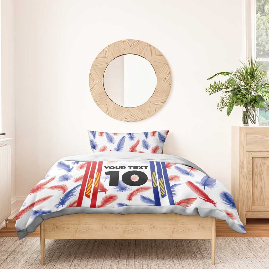 Duvet cover with feather and striped design, showing custom “YOUR TEXT” 10; paired pillowcases