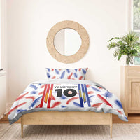 Duvet cover with feather and striped design, showing custom “YOUR TEXT” 10; paired pillowcases