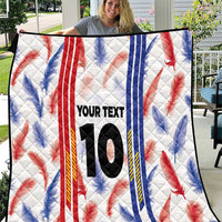 White quilt blanket with red and blue leaf pattern, vertical stripes, and large number 10