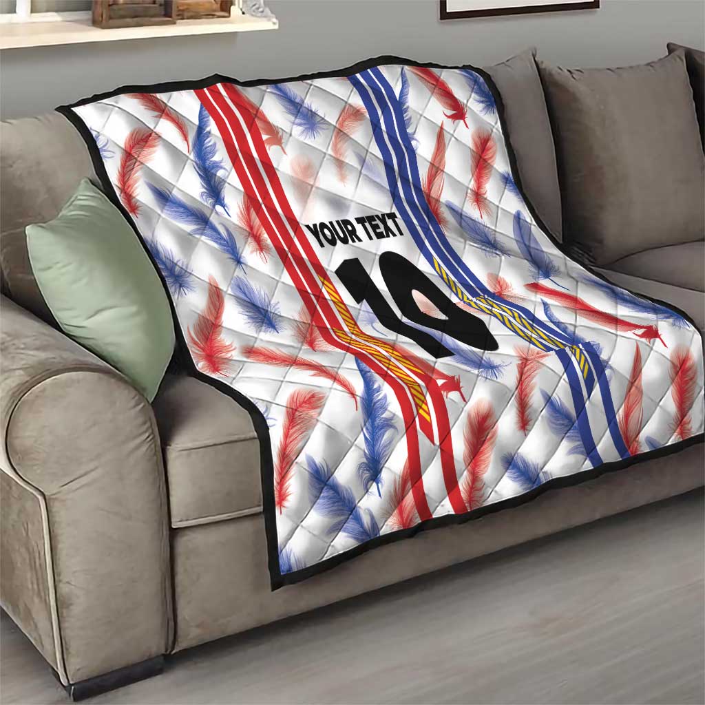 White quilt blanket on a sofa with red and blue leaf pattern, “YOUR TEXT”, and number 10