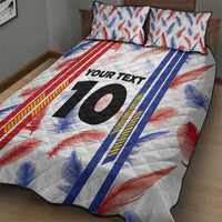Quilt bed set with pillowcases, white base with red and blue feather print, big black '10'