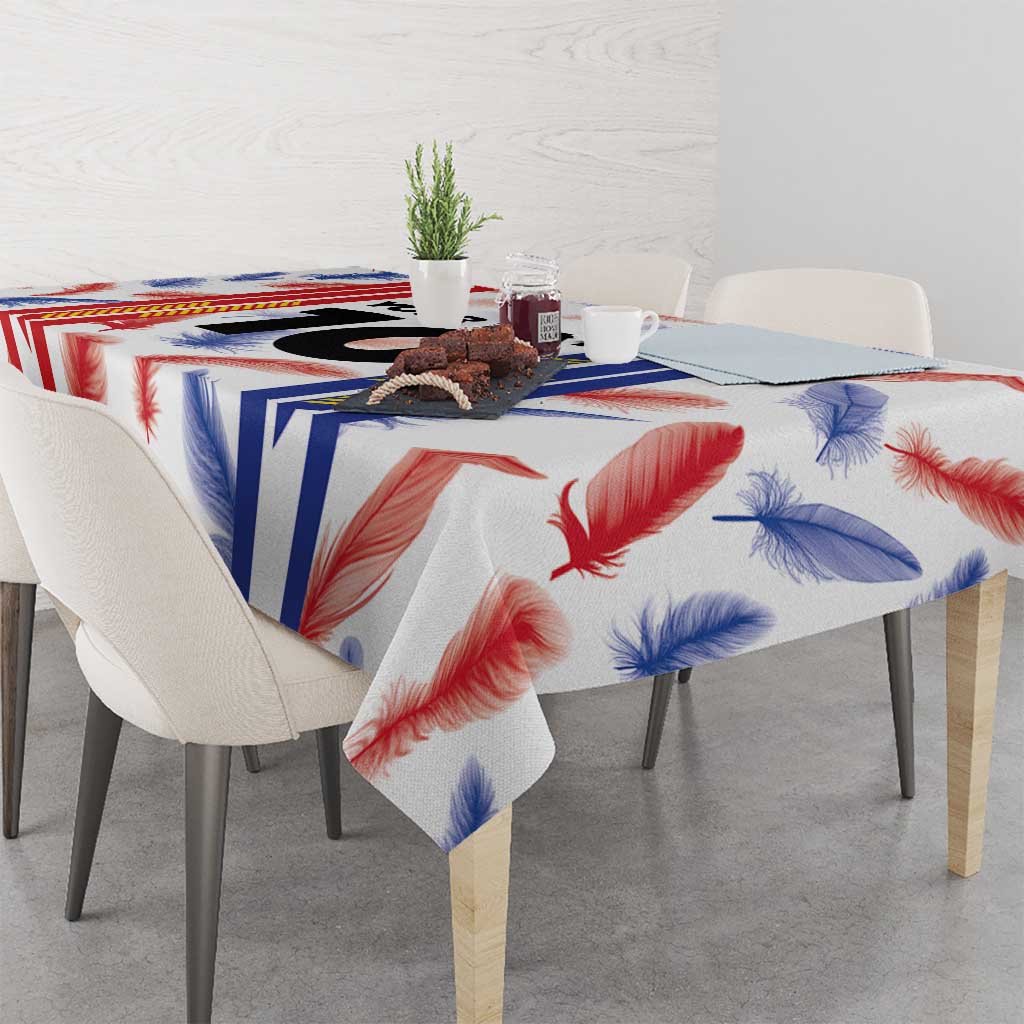 Custom football jersey tablecloth with multicolor feather print and stripe motif on table.