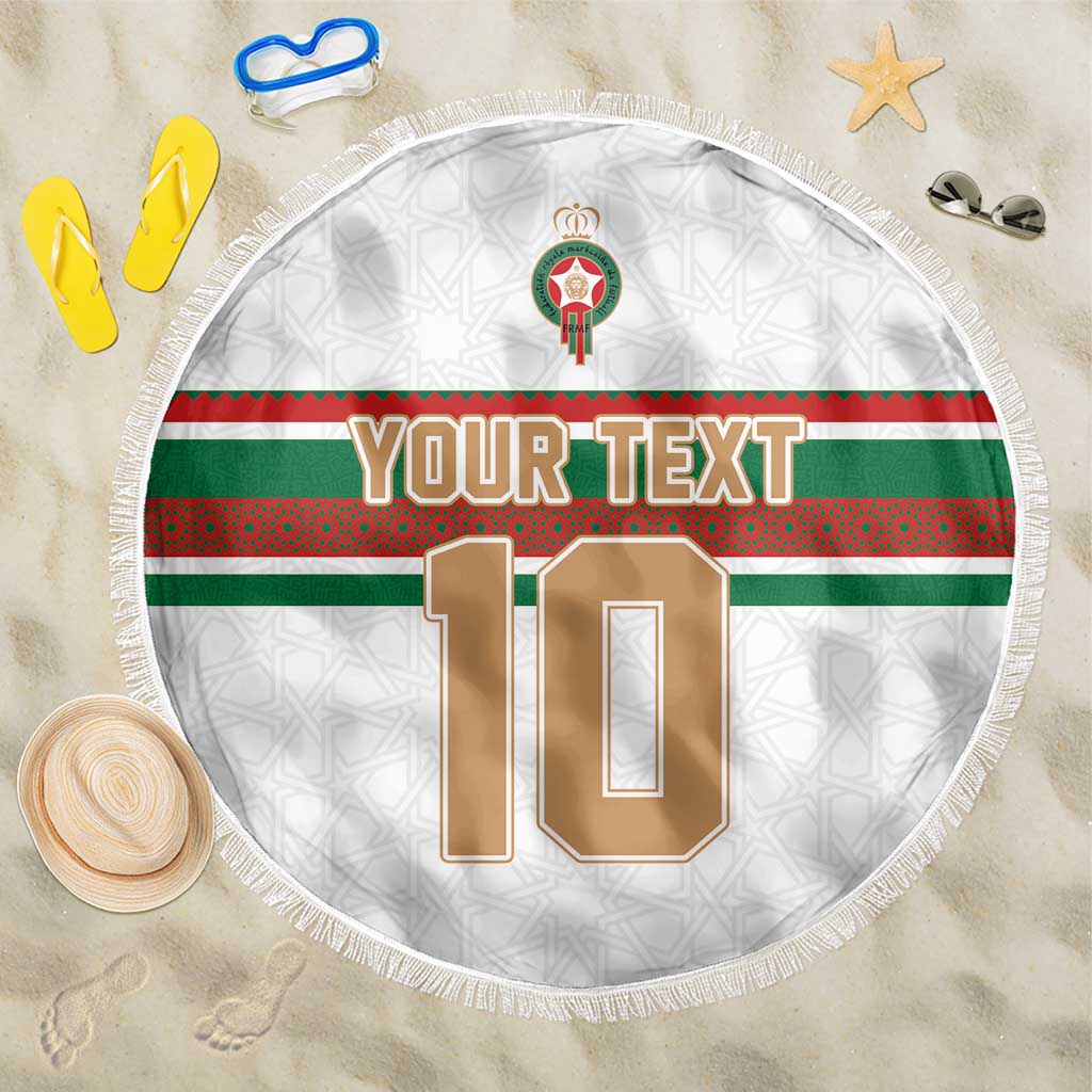 Round white football beach blanket with green and red band and fringed edge