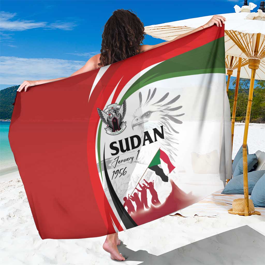 White Sudan flag sarong with red and green circular design, draped over shoulders