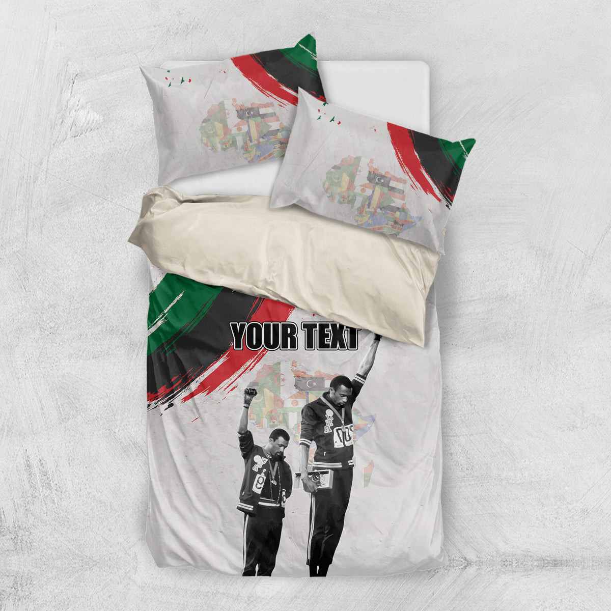 White bedding set viewed from above with “YOUR TEXT,” black-and-white figures, red/green artwork