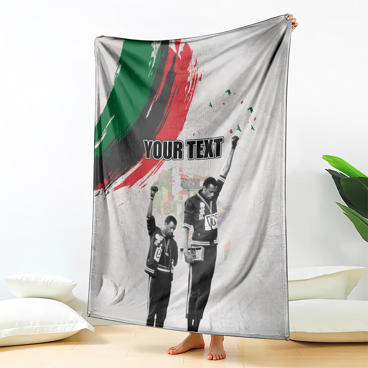 Light gray personalized blanket with green-red brush stripe and standing black-and-white figures