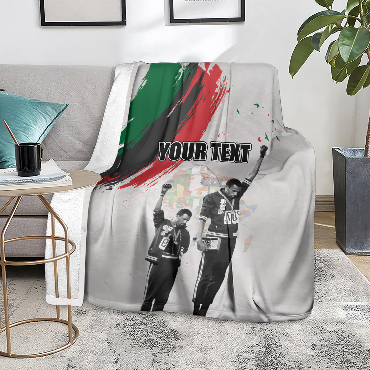 Light gray personalized blanket on sofa with green-red brush stripe and “YOUR TEXT”