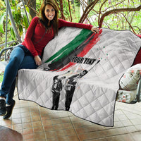 White quilt draped on outdoor seating with green/red brushstroke, black-and-white figures, 'YOUR TEXT'