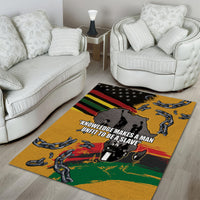 Yellow area rug with chains, black silhouette figure, and multicolor flag stripe border